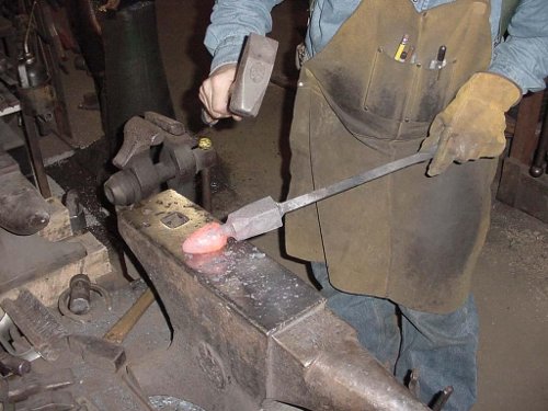 Ken forging an egg with a hammer and anvil.
